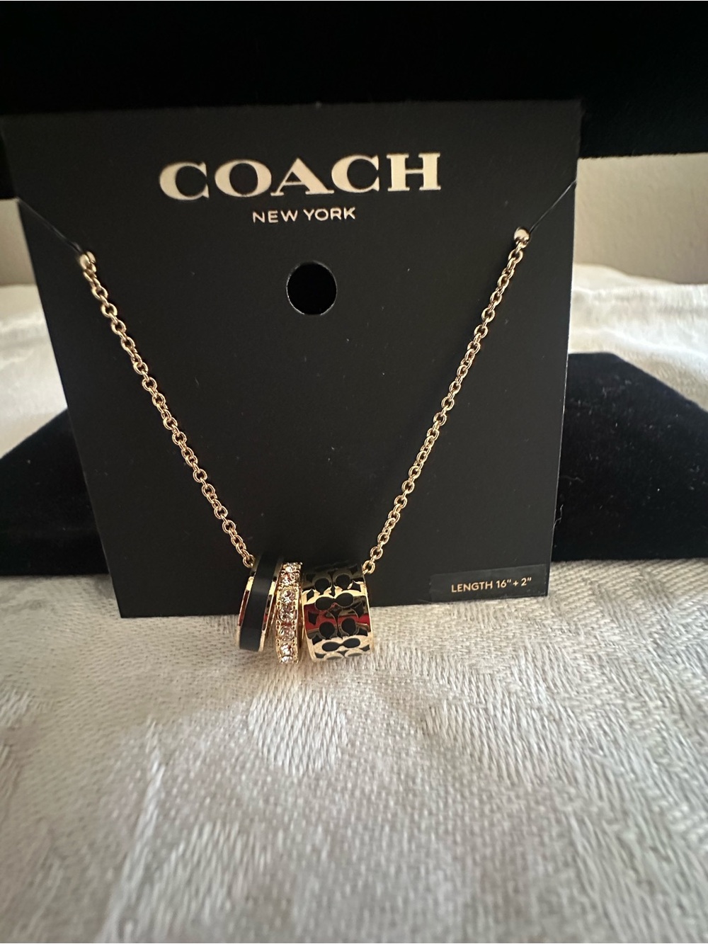 COACH Gold-Tone Signature Ring Pendant Necklace in Black and Gold
